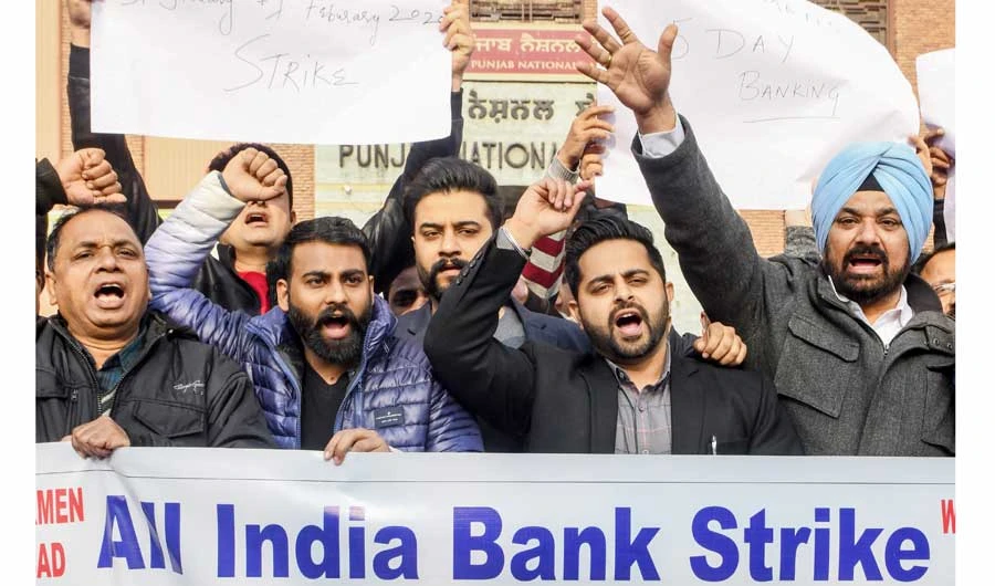 Employees stage a demonstration in Amritsar on Friday during a nationwide bank strike, adding to the economic challenges facing the Indian government. (AFP)