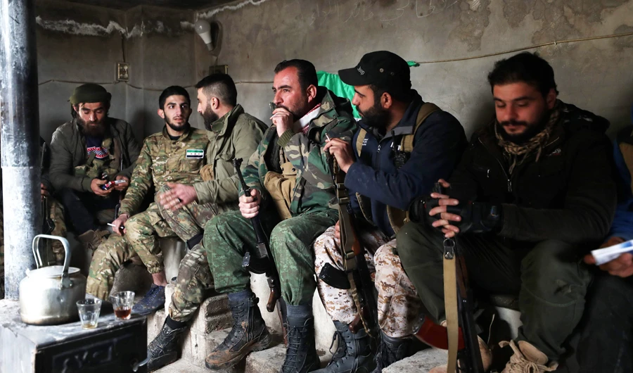 Syrian rebel fighters rest inside a cement bunker before returning to the front in the town of Saraqeb, in the northwestern Idlib province on Saturday. (AFP)