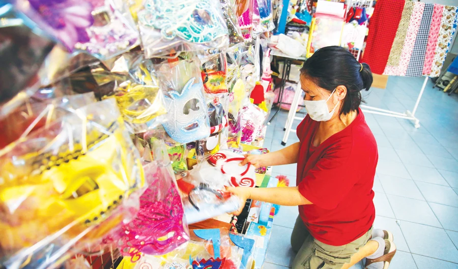 A shop owner arranges souvenir gifts as she waits for tourists at her shop in Phuket. The normally busy holiday destination is all but empty as alarm grows over the coronavirus outbreak. (Reuters)