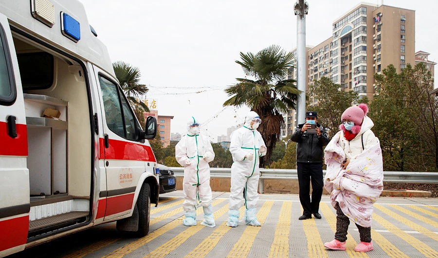 Hospital staff in protective garments pick up a leukaemia patient who arrived from the Hubei province exclusion zone at a checkpoint at the Jiujiang Yangtze River Bridge in Jiujiang, Jiangxi province, China, as the country is hit by an outbreak of a new coronavirus, February 1, 2020. (REUTERS)