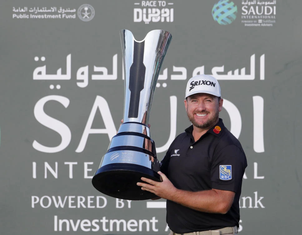 Graeme McDowell from Northern Ireland celebrates with the trophy after he wins the final round of the Saudi International at Royal Greens Golf and Country Club, Sunday, Feb. 2, 2020. (AP)