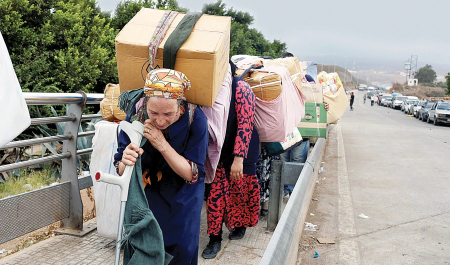 Moroccan women carry goods to be taken across the border from Spain’s North African enclave into Beni Ansar in Morocco. (Reuters)
