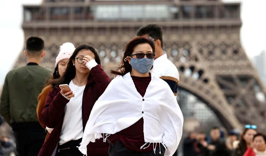 A woman wears a protective mask in light of the coronavirus outbreak in China as she walks at the Trocadero esplanade in front of the Eiffel Tower in Paris, France, February 1, 2020. (Reuters)