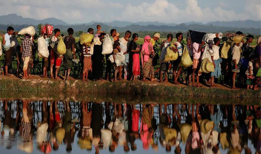In this file photo, Rohingya refugees who fled from Myanmar were standing outside Bangladeshi border guards after crossing the border in Palang Khali, Bangladesh October 9, 2017. (REUTERS)