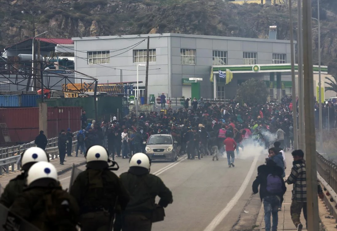 Riot police use tear gas against protesting refugees and migrants during a demonstration on the northeastern Aegean island of Lesbos. (AP Photo)