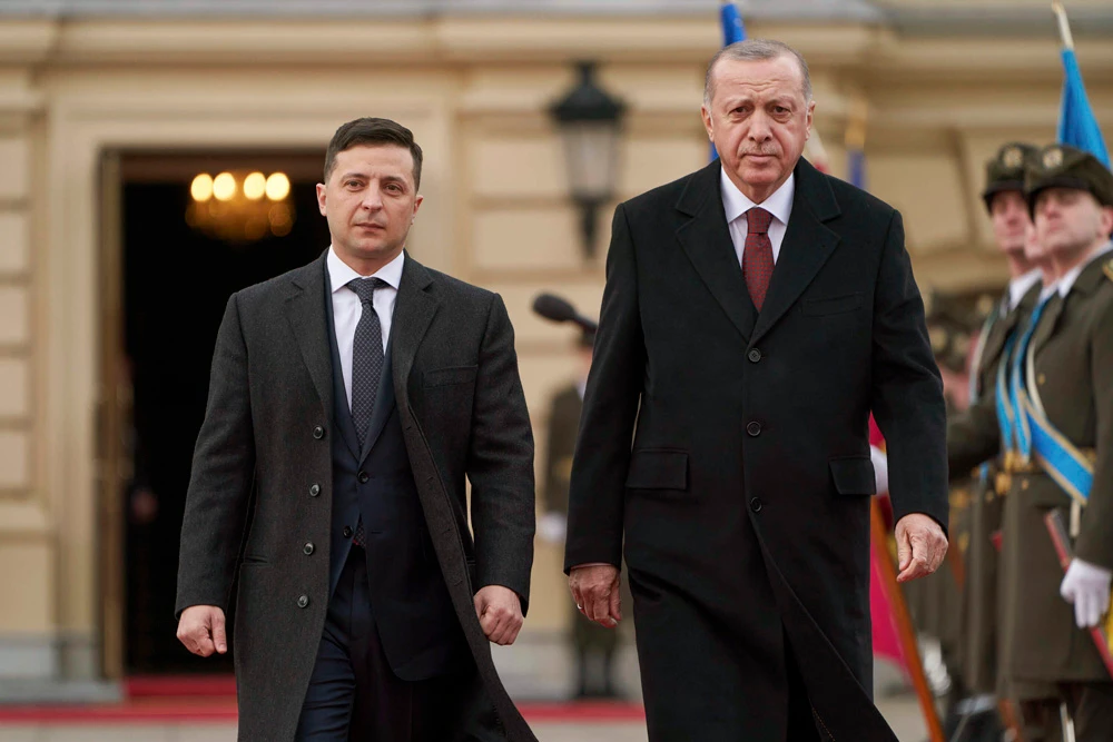 Ukrainian President Volodymyr Zelenskiy, left, and Turkey’s President Recep Tayyip Erdogan review the honor guard during a welcome ceremony ahead of their meeting in Kyiv, Ukraine, Monday, Feb. 3, 2020. (AP Photo)