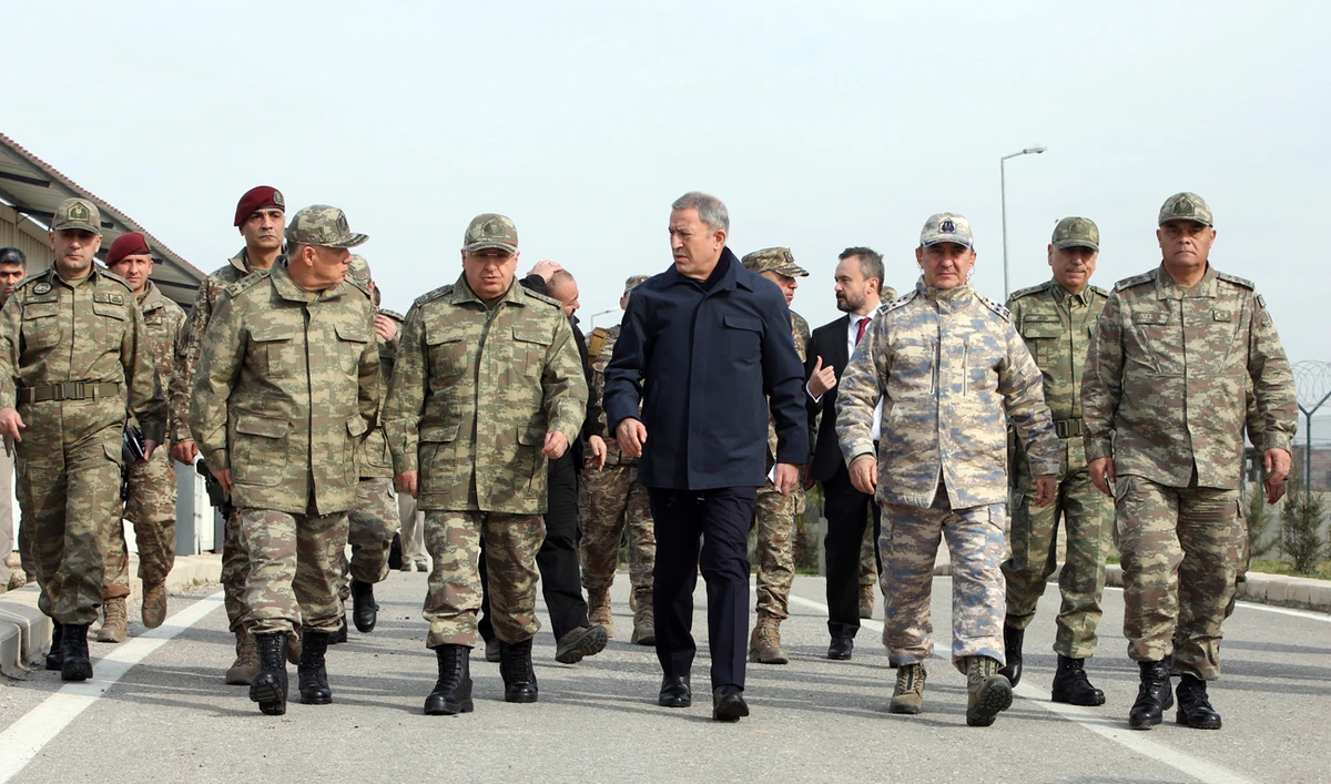Turkey's National Defence Minister Hulusi Akar, center, and Turkish army's top commanders arrive to inspect troops at the border with Syria, in Hatay, Turkey. (AP)