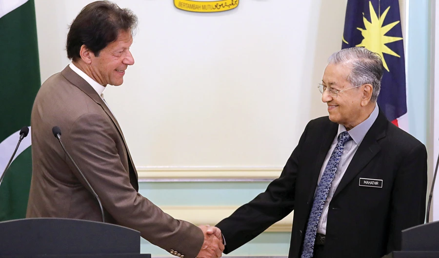 Pakistan’s Prime Minister Imran Khan shakes hands with Malaysia’s Prime Minister Mahathir Mohamad after a joint news conference in Putrajaya, Malaysia, on Tuesday. (Reuters)