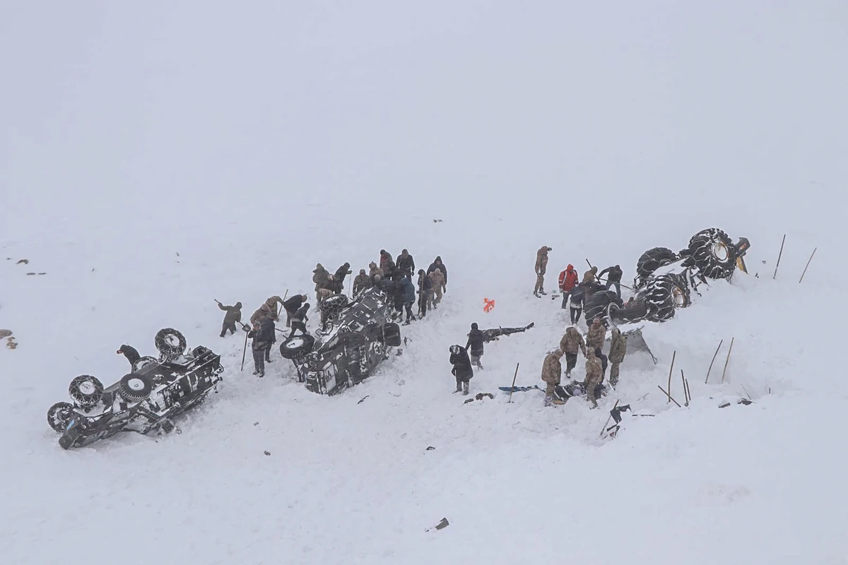 Emergency service members dig in the snow around at least three overturned vehicles, near the town of Bahcesehir, in the eastern Turkey province of Van, on February 5, 2020 as some dozens of rescue workers are missing after being hit by a second avalanche while on a mission to find two people missing in a previous snow-slide that struck late on February 4. (AFP)