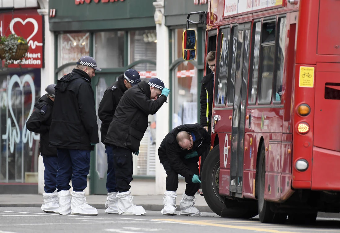 Police officers inspect a bus as they work at the scene of Sunday's terror stabbing attack in the Streatham area of south London Monday Feb. 3, 2020. (AP)