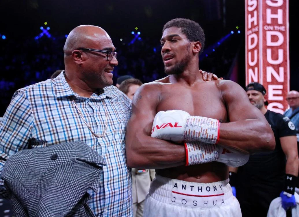 Anthony Joshua celebrates winning his fight against Andy Ruiz Jr with his dad Robert Joshua at Diriyah Arena, Diriyah, Saudi Arabia. (Reuters)
