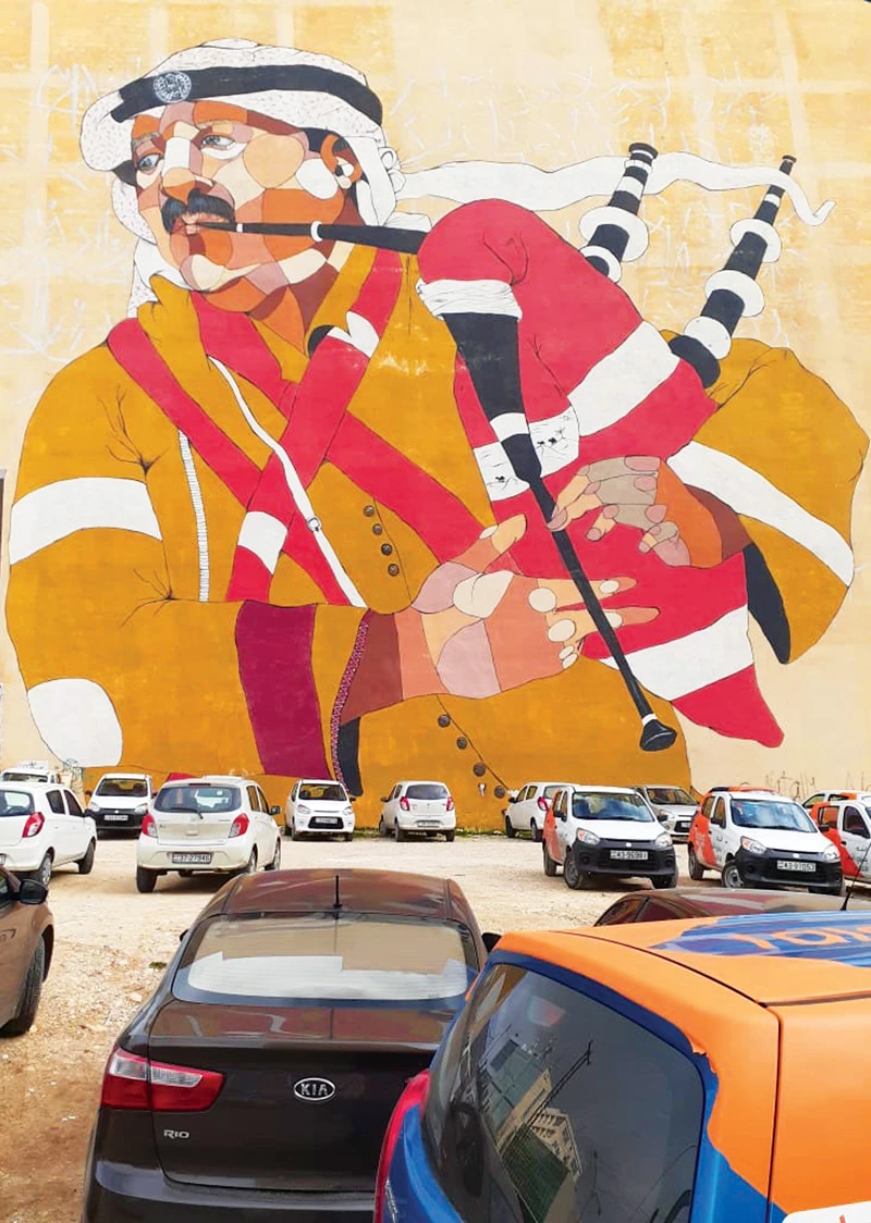 The mural in Khalda district in Amman of a Jordanian piper. (Ahmad Said)