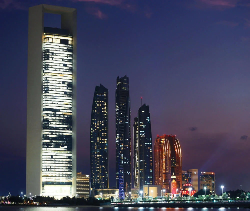 ADNOC headquarters, left, in Abu Dhabi. ADNOC is seeking a minimum free float of 15 percent to attract international investors, sources say. (Reuters)