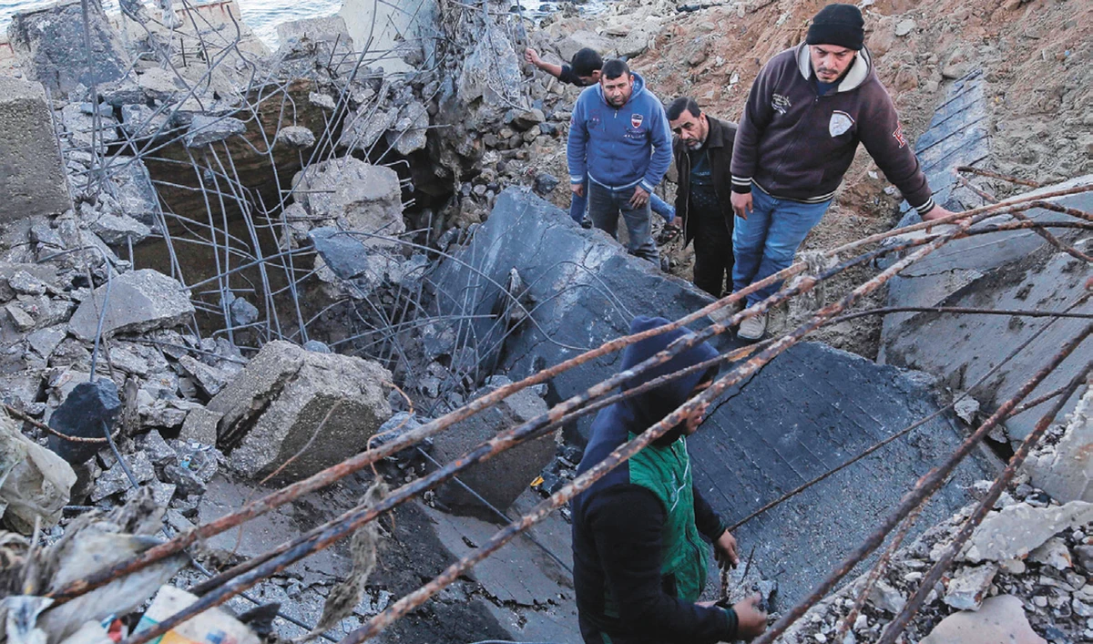 Palestinians inspect the site of an Israeli airstrike in Gaza City on Thursday. (AFP)