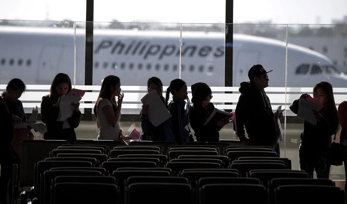 Bello cited an agreement on the standard employment contract for overseas Filipino workers as a reason for lifting the block. (AFP)