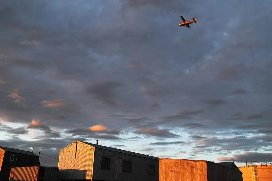 A plane flies over the town after taking off from the dirt runway on September 14, 2019 in Kivalina, Alaska. (File/AFP)
