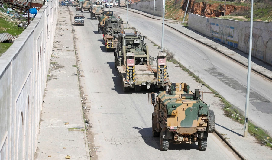 A Turkish military convoy of tanks and armored vehicles passes near the city of Idlib, in northwestern Syria, near the Syria-Turkey border, on Saturday. (AFP)