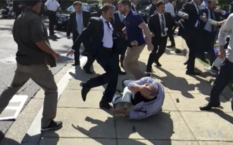 Members of Turkish President Recep Tayyip Erdogan's security detail attack protesters during Erdogan's 2017 trip to Washington. (AP/File photo)