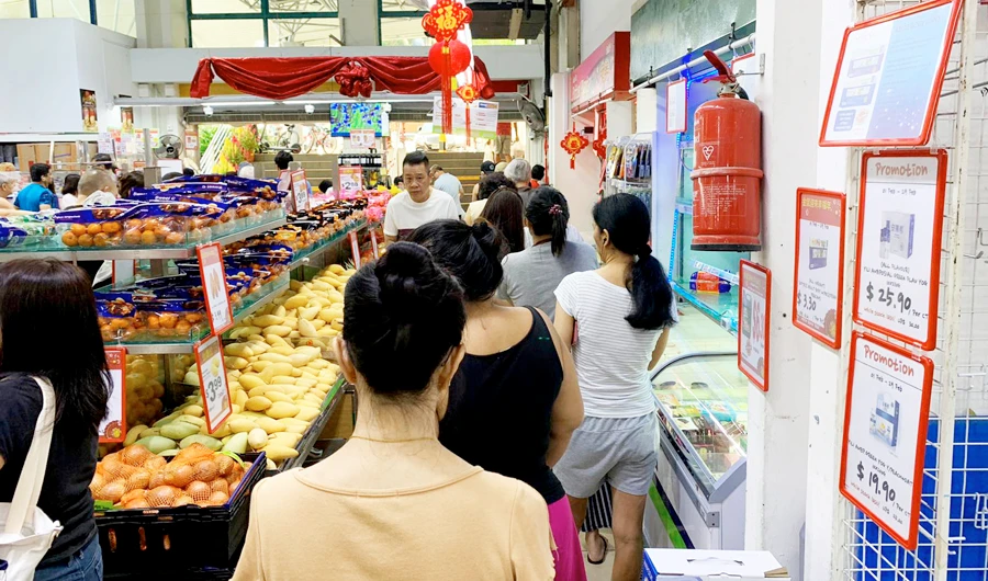 People queue at a grocery store in Singapore after panic buying swept the city amid growing alarm over the coronavirus. (AFP)