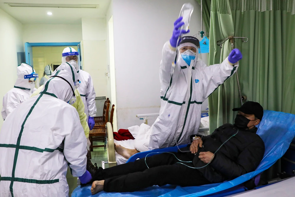 Medical workers move a man into the isolation ward for 2019-nCoV patients at a hospital in Wuhan in central China's Hubei province. (Chinatopix via AP)