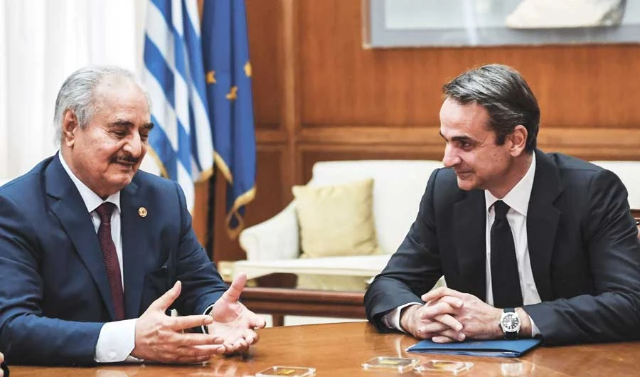 Libyan commander Khalifa Haftar, left, speaks with Greek Prime Minister Kyriakos Mitsotakis. Greece has sought to bolster its Mediterranean presence in recent weeks and boost cooperation with the US and France, risking heightened tension with Turkey and sparking accusations of adventurism. (AFP)