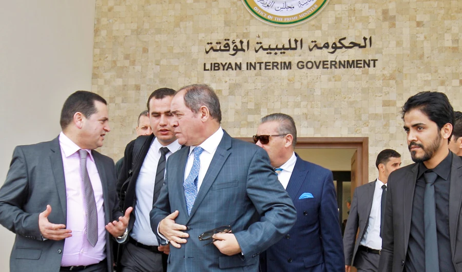 Algeria's foreign minister Sabri Boukadoum (C) leaves the headquarters of Libya's parallel eastern government after meeting with its foreign minister Abdulhadi Lahweej (L), in the coastal city of Benghazi in eastern Libya, on February 5, 2020, during a visit to discuss Algiers' efforts for a political solution to the Libyan conflict. (AFP)