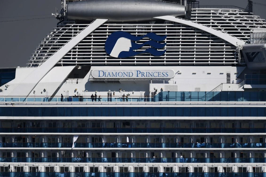 Passengers stand on balconies on the Diamond Princess cruise ship, with around 3,600 people quarantined onboard due to fears of the new coronavirus, at the Daikoku Pier Cruise Terminal in Yokohama port. (AFP)