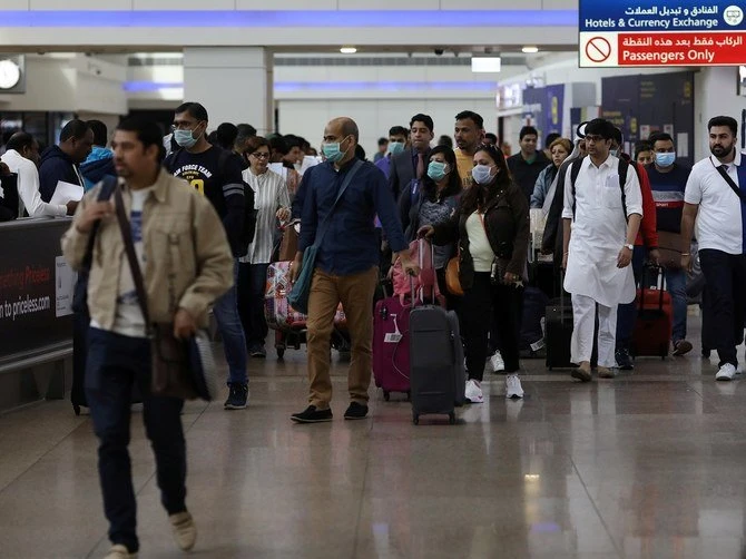 Travellers wear masks as they arrive at the Dubai International Airport. (Reuters/File photo)