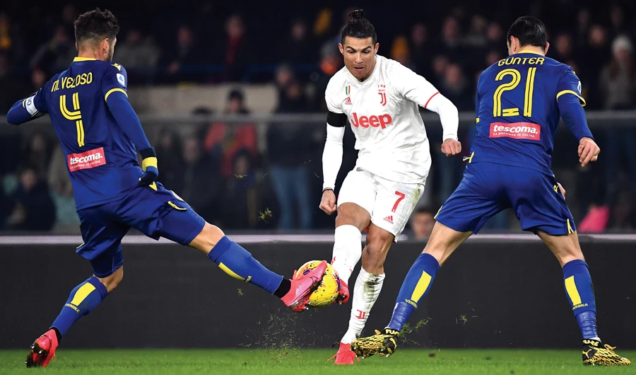 Cristiano Ronaldo, center, fights for the ball during a football match between Hellas Verona and Juventus in Verona on Saturday. (AFP)