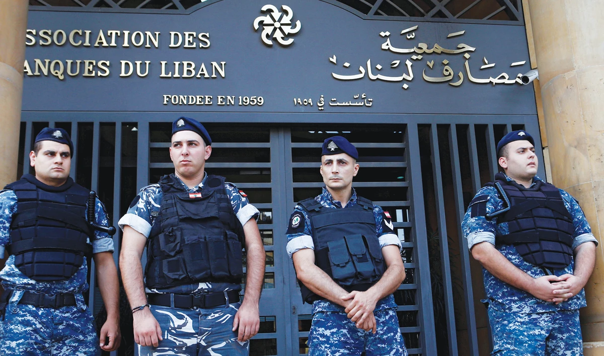 Lebanese police stand outside the Association of Banks in downtown Beirut as the Central Bank’s foreign currency reserves contract. (Reuters)