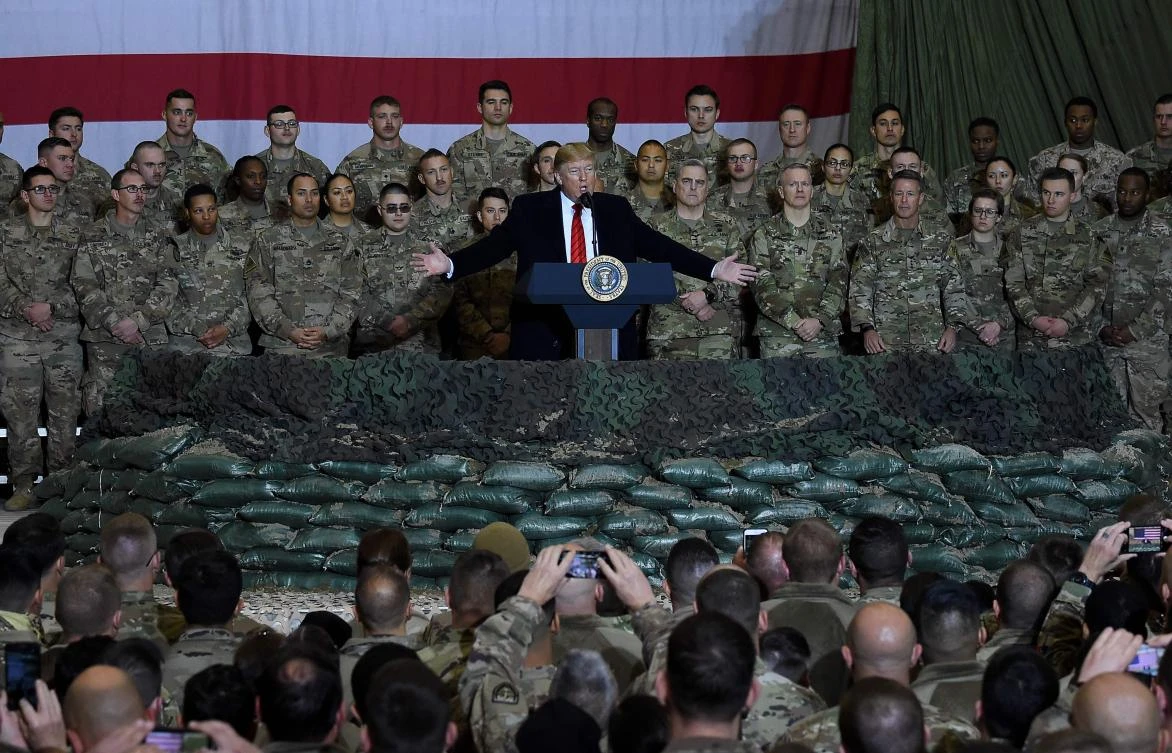 In this file photo taken on November 28, 2019 US President Donald Trump speaks to the troops during a surprise Thanksgiving day visit at Bagram Air Field,in Afghanistan. The United States has secured a seven-day reduction in violence in talks to help seek a negotiated settlement in Afghanistan, Pentagon chief Mark Esper said February 13, 2020. (AFP)