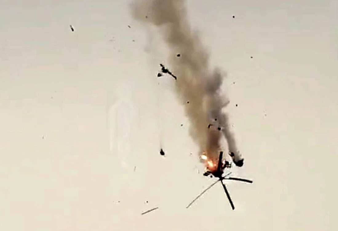 An image grab taken from a video published by jihadists of the Hayat Tahrir al-Sham (HTS) allegedly shows a Syrian military helicopter being downed on February 12, 2020 in Syria's war-torn province of Idlib. (AFP/HO/HTS)