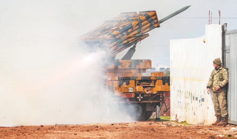 A Turkish military mobile rocket launcher fires from a position in Idlib toward Syrian regime forces’ positions on Friday. (AFP)