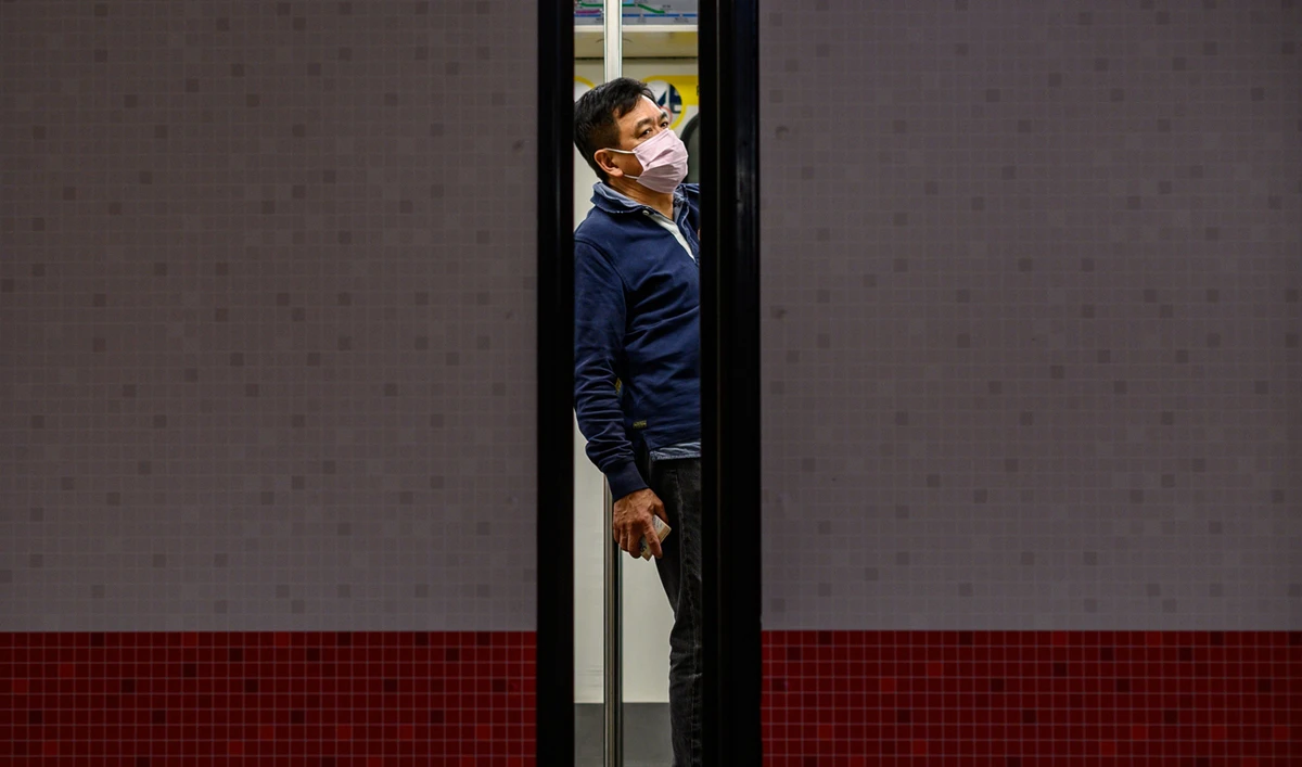 A man wears a face mask as a preventative measure against the COVID-19 coronavirus, as he stands in a train at Mong Kok MTR station in Hong Kong. (AFP)
