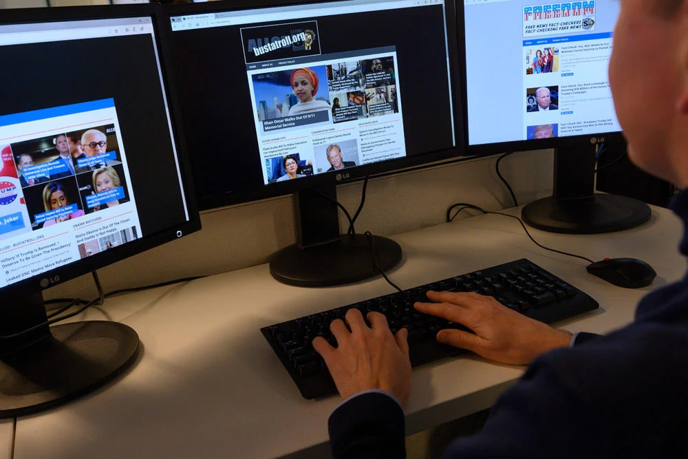 An AFP journalist looks at websites that are part of Christopher Blair's "America's Last Line of Defense" network in Washington, D,C, on Feb, 13, 2020. (AFP / Eric Baradat)
