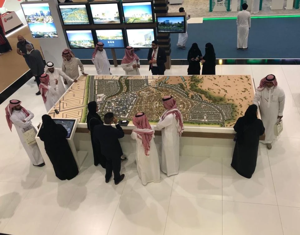 Above, a scaled version of Dar Al-Arkan’s Shams Ar Riyadh project on display during a property show in Riyadh last year. (Dar Al-Arkan Real Estate Development)
