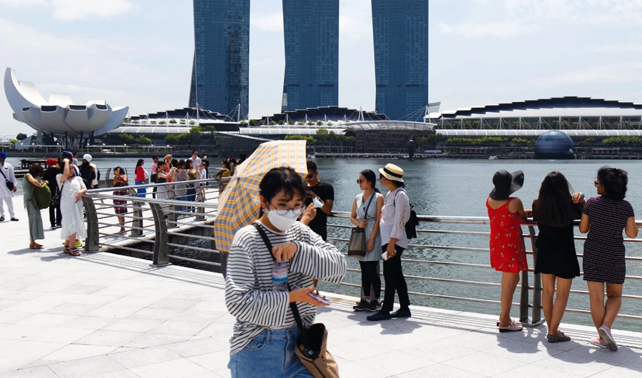 Singapore lowers growth forecast as virus hits economy