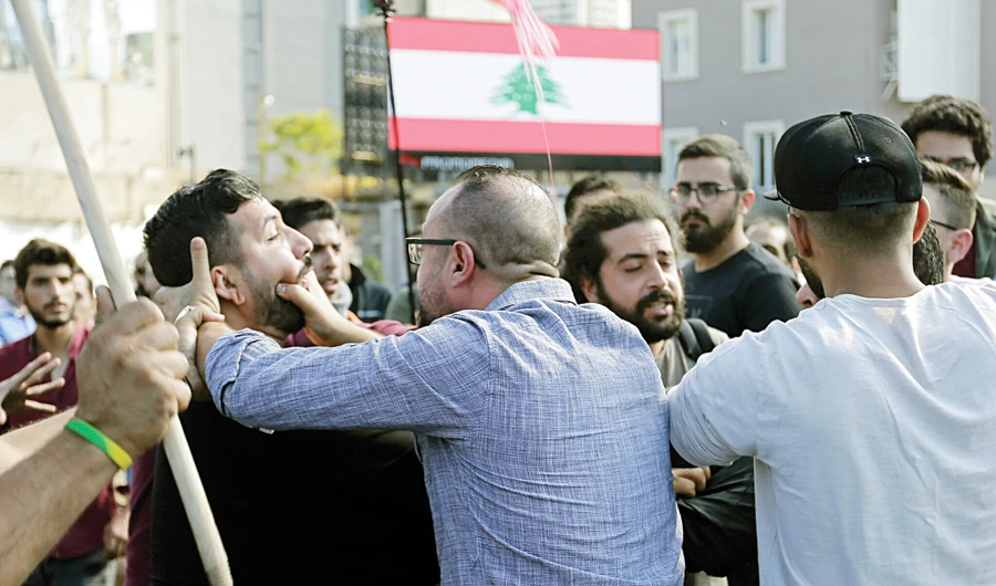 Hezbollah supporters, foreground, fight with anti-government protesters in Beirut, as clashes erupt between them during ongoing protest demonstrations in Lebanon. (AP/File)