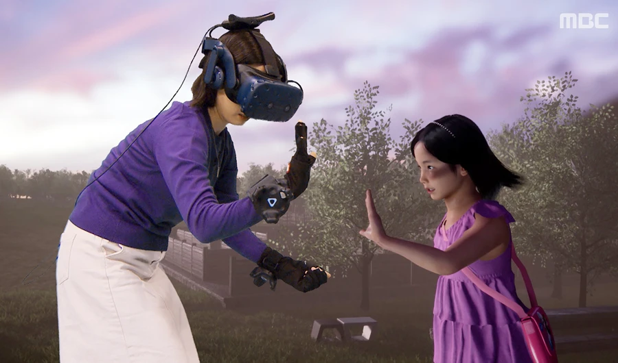 This undated handout photo provided on February 14, 2020 by South Korea's Munhwa Broadcasting Corporation (MBC) in Seoul shows a scene of a documentary "I met you" where a mother meets her dead daughter through virtual reality. (AFP)