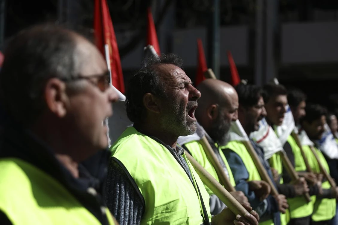 Members of the communist-backed labor union PAME shout slogans during a rally in Athens, Tuesday, Feb. 18, 2020. (AP)
