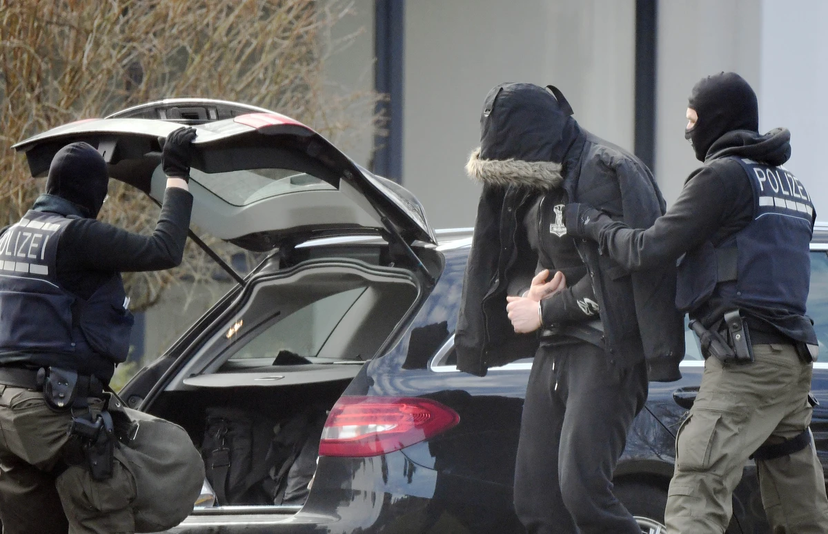 Twelve men were arrested in police raids nationwide, uncovering a stash of weapons that included a pistol, a homemade gun, hand grenades, axes and a crossbow. (AFP)