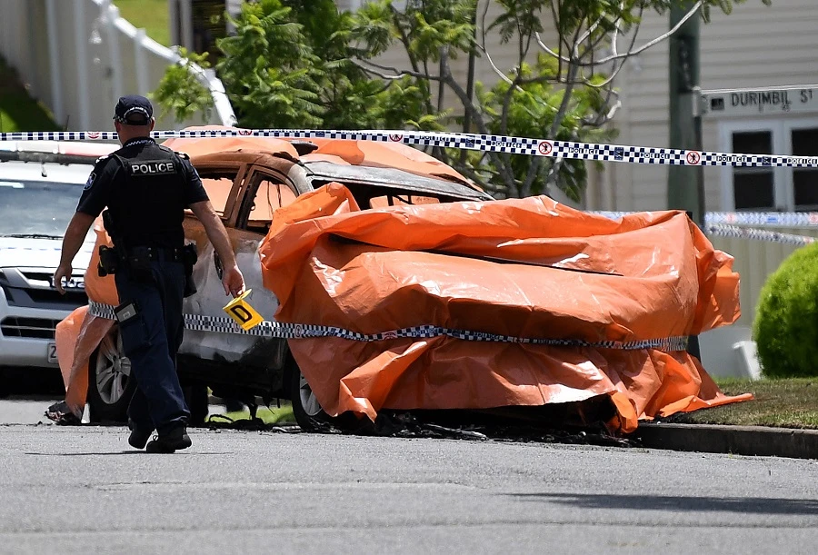 Police work at the scene of a car fire in Brisbane, Australia, 19 February 2020. (EPA)