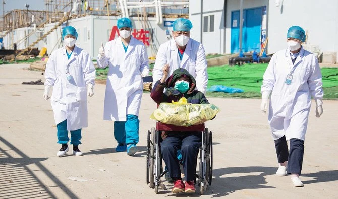 A recovered patient (C in wheelchair), 83, is discharged from Leishenshan Hospital, the newly-built makeshift hospital for novel coronavirus patients, in Wuhan in China's central Hubei province on February 18, 2020. (AFP)