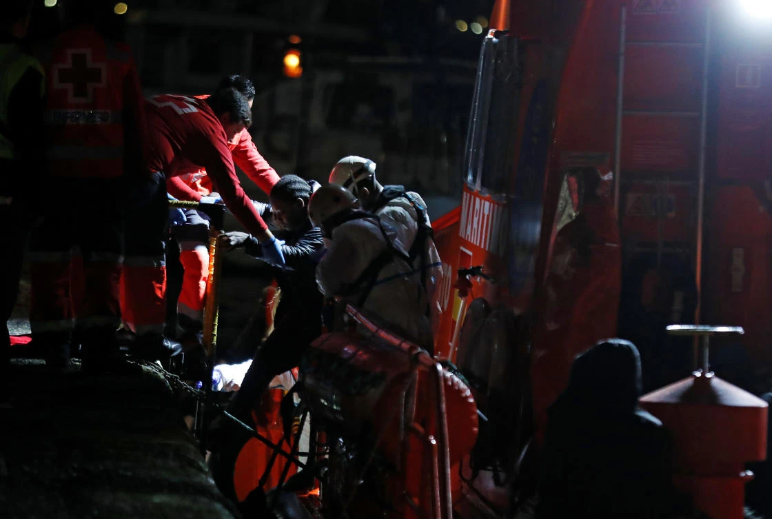 A migrant rescued in the Atlantic Ocean disembarks from a Spanish coast guard vessel in the port of Arguineguin on the island of Gran Canaria, Spain, February 18, 2020. (Reuters)