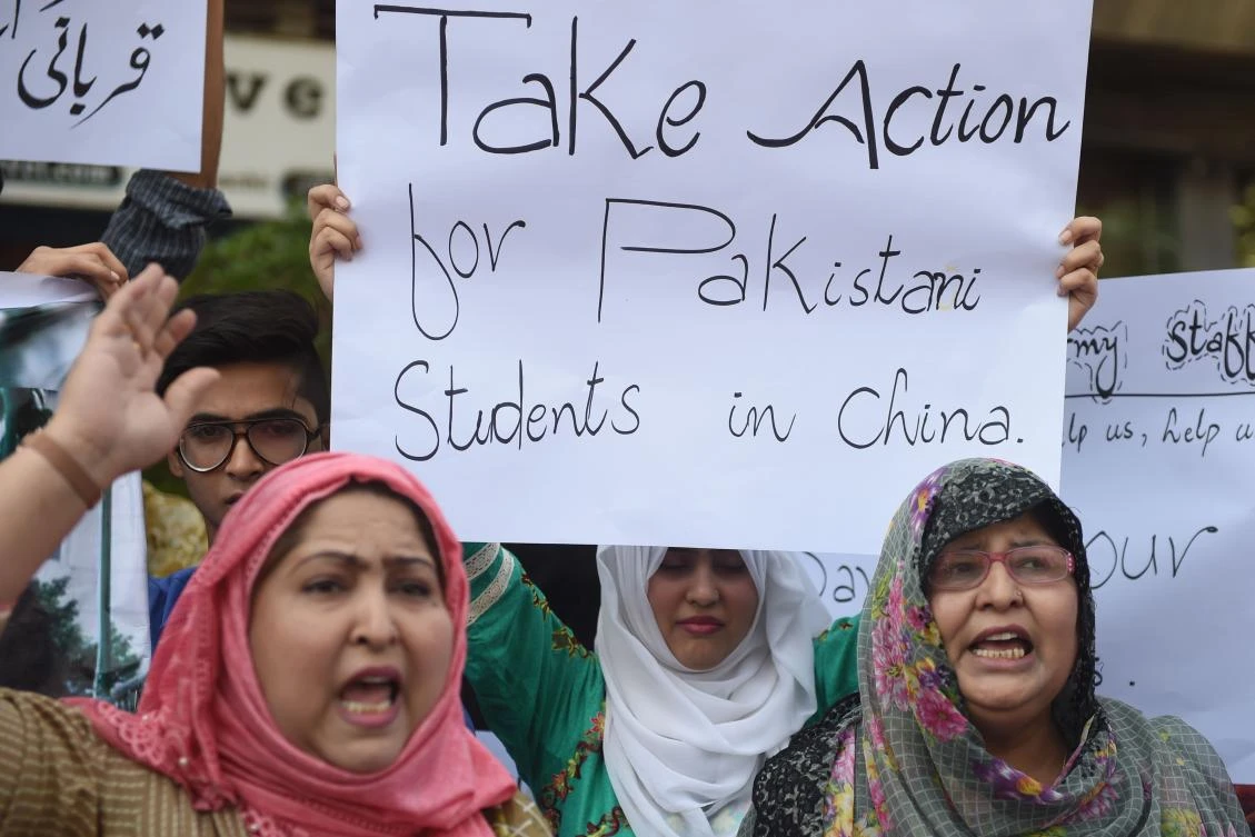 Parents and relatives of Pakistani students studying in the Chinese city of Wuhan hold placards during a protest to demand the government the evacuation of their loved ones in Karachi on Feb. 16, 2020. (AFP)
