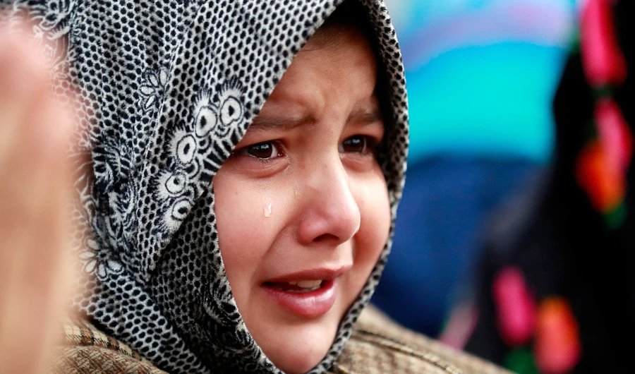 A girl weeps during the funeral of Raja Umar Maqbool Bhat, a suspected militant, who was killed in a gunbattle with Indian soldiers, in Lurgam village in south Kashmir’s Tral town. (Reuters)
