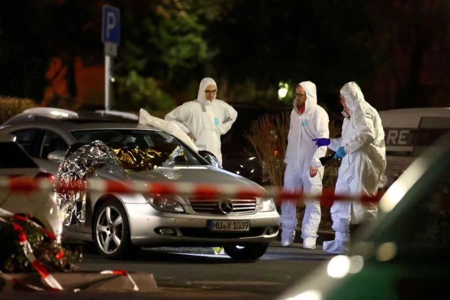 Forensic experts work around a damaged car after a shooting in Hanau near Frankfurt, Germany, February 20, 2020. (Reuters)