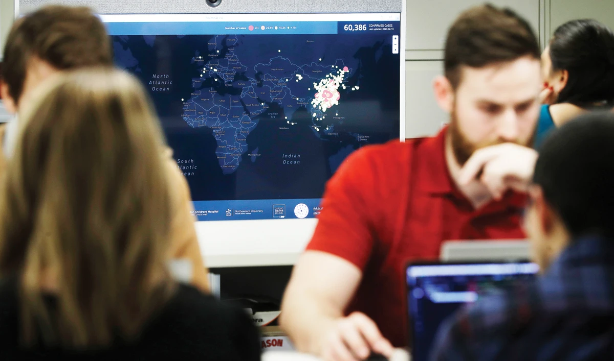 A worker at HealthMap, a system using AI to monitor global disease outbreaks, updates health data at Boston Children’s Hospital in the US. (AP)