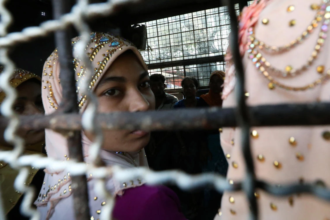 Arrested Rohingya people arrive at a Hlegu court to face charges of traveling illegally. (REUTERS)