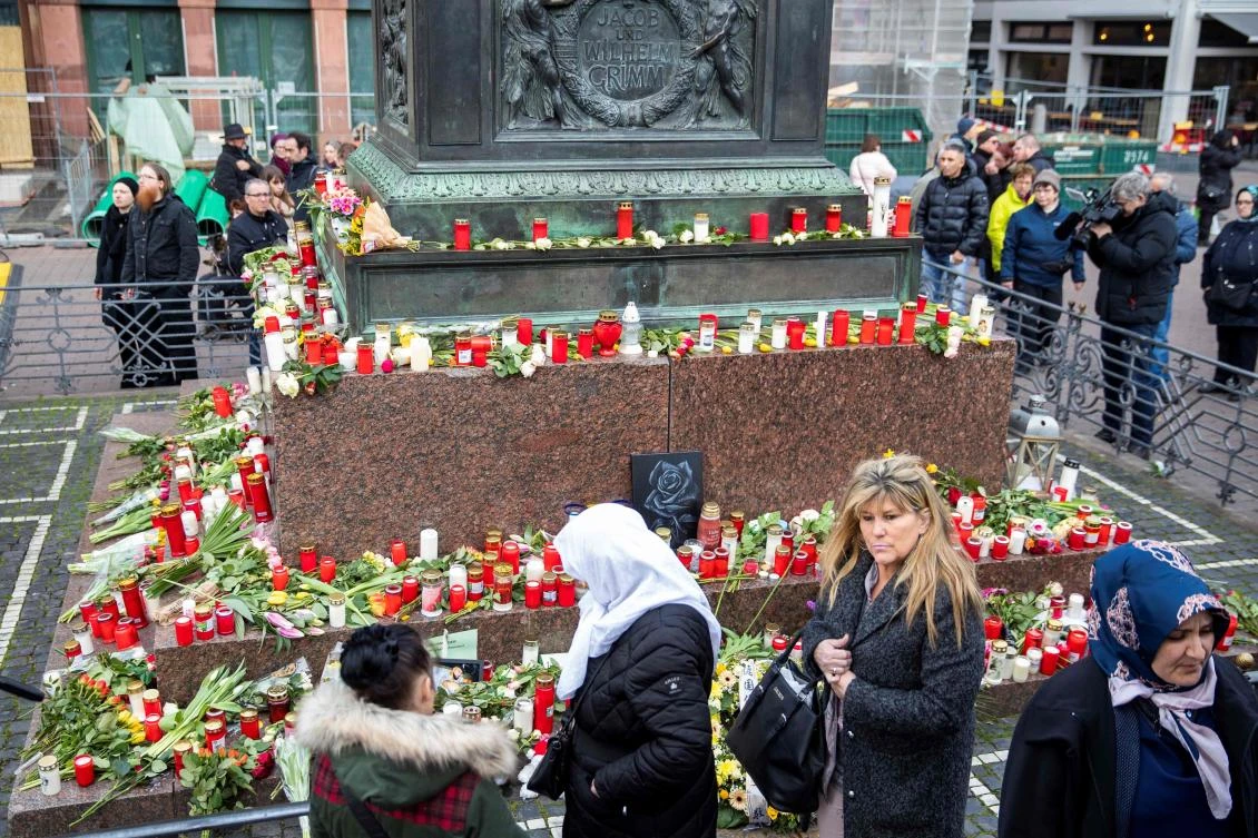 People pay their respects at a makeshift memorial set up at the market square (Marktplatz) in Hanau near Frankfurt am Main, Germany, two days after a gunman killed nine in a racist attack. (AFP)